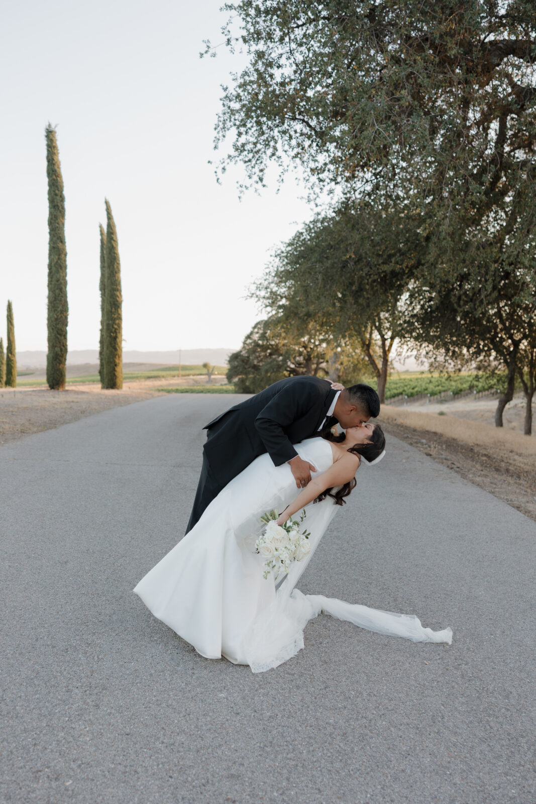 Newlyweds embracing during golden hour at a California wedding photographed by Kassidy Klicks