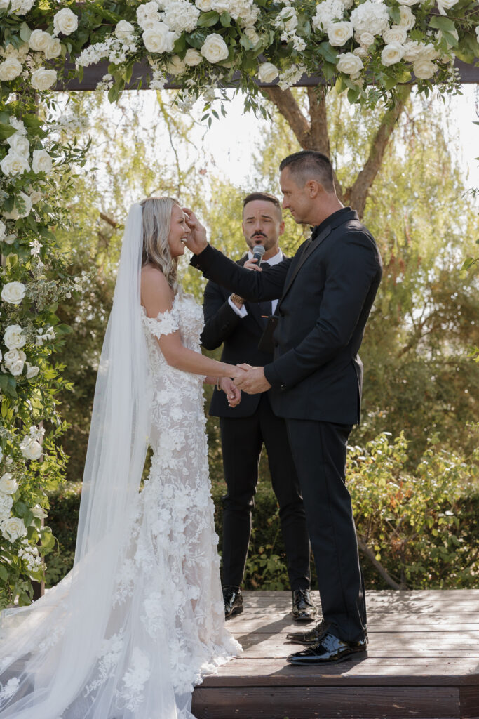 Bride and groom heartfelt moment during ceremony at Falkner Winery