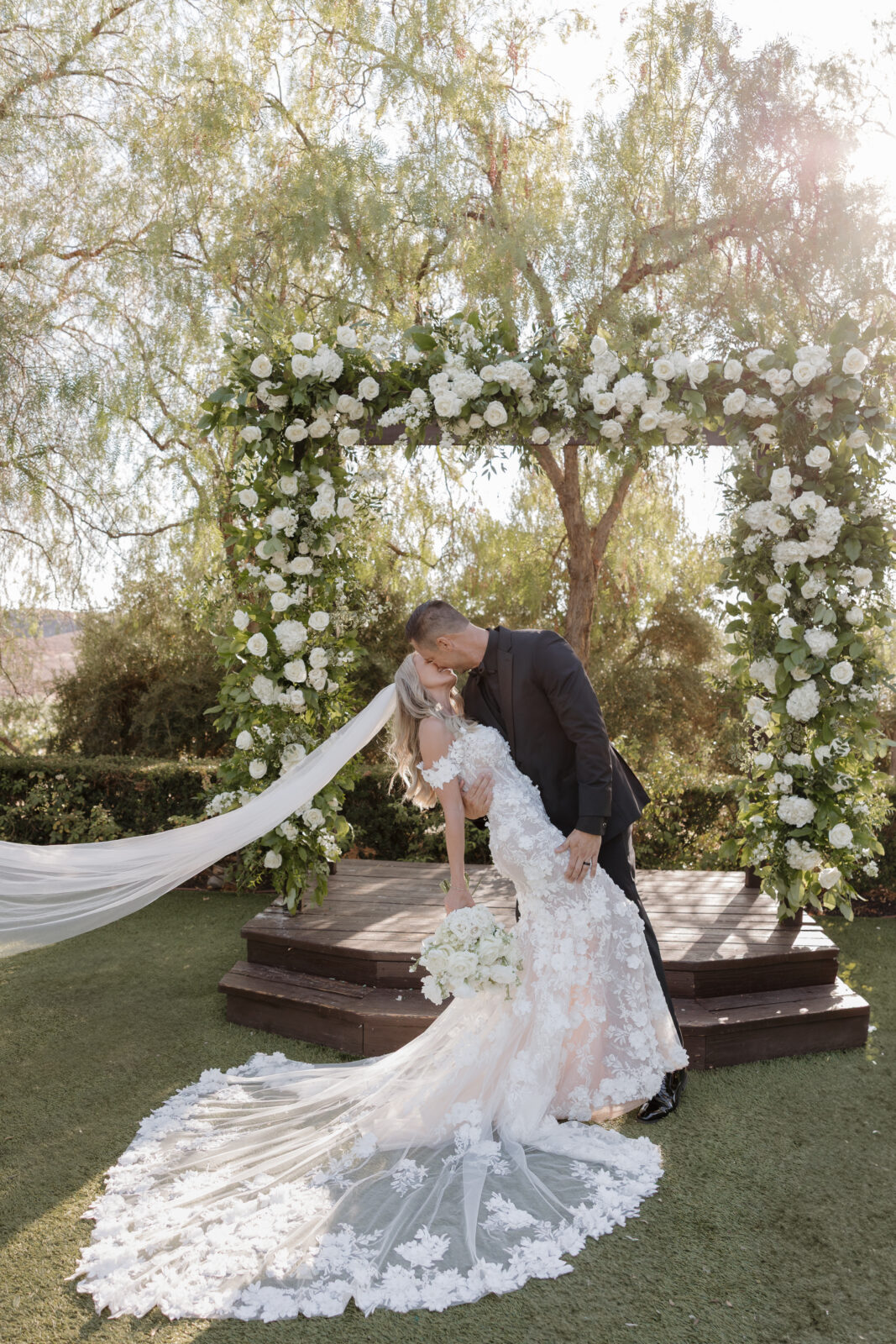 Bride and groom first kiss at Falkner Winery Wedding Venue Temecula, CA