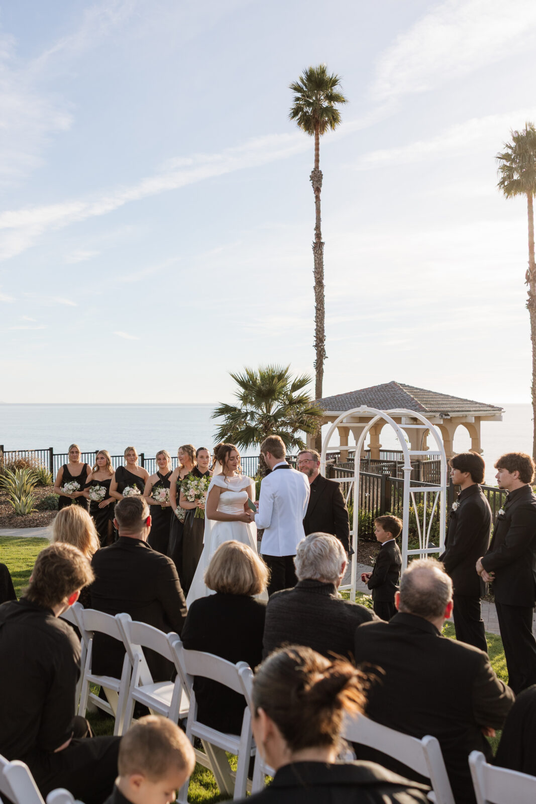 Bride and groom exchanging vows during cliffside wedding ceremony overlooking the ocean in Pismo Beach, California, captured by Southern California wedding photographer