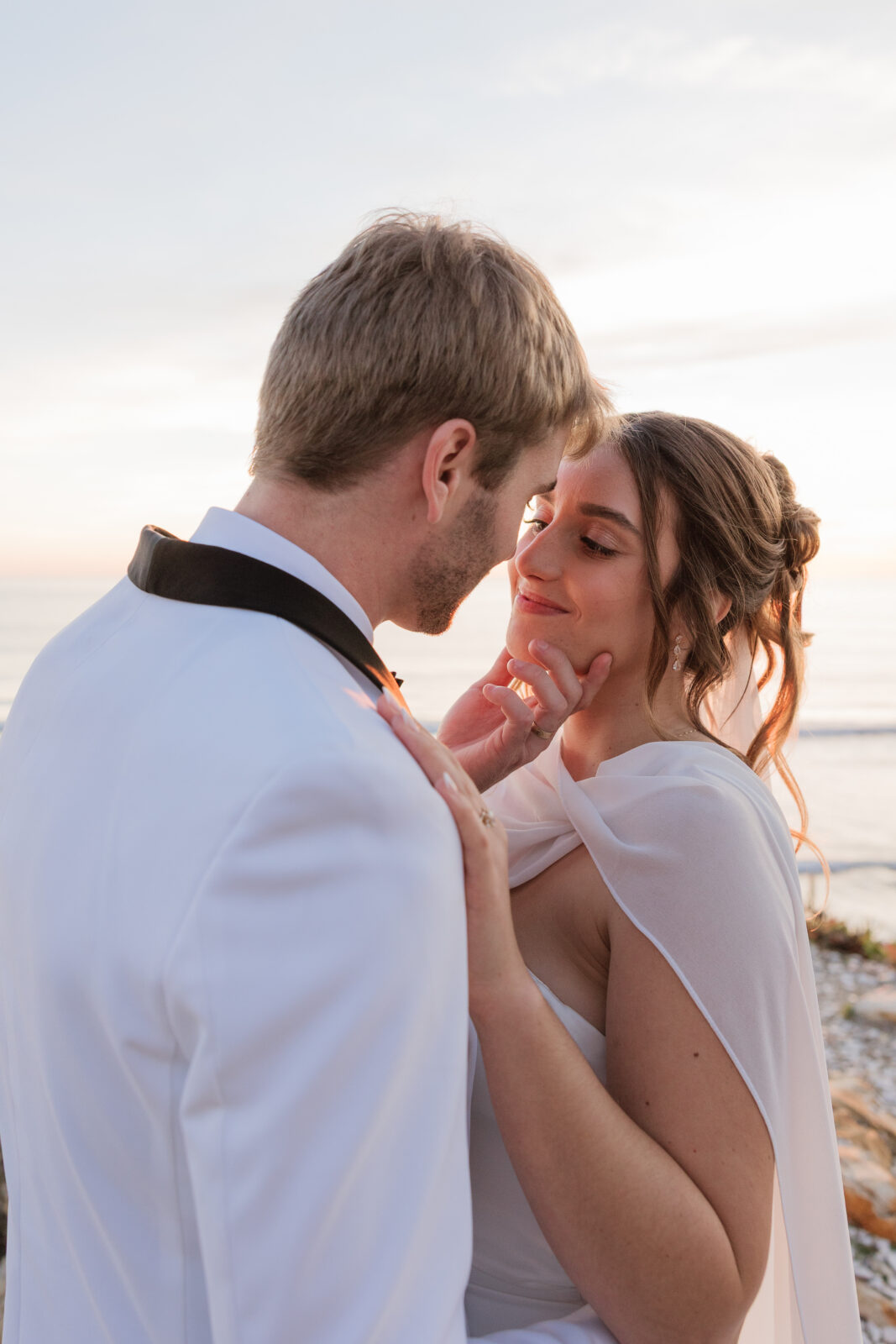 Bride and groom laughing and enjoying a playful moment together on their wedding day in Pismo Beach, California, captured by Southern California wedding photographer