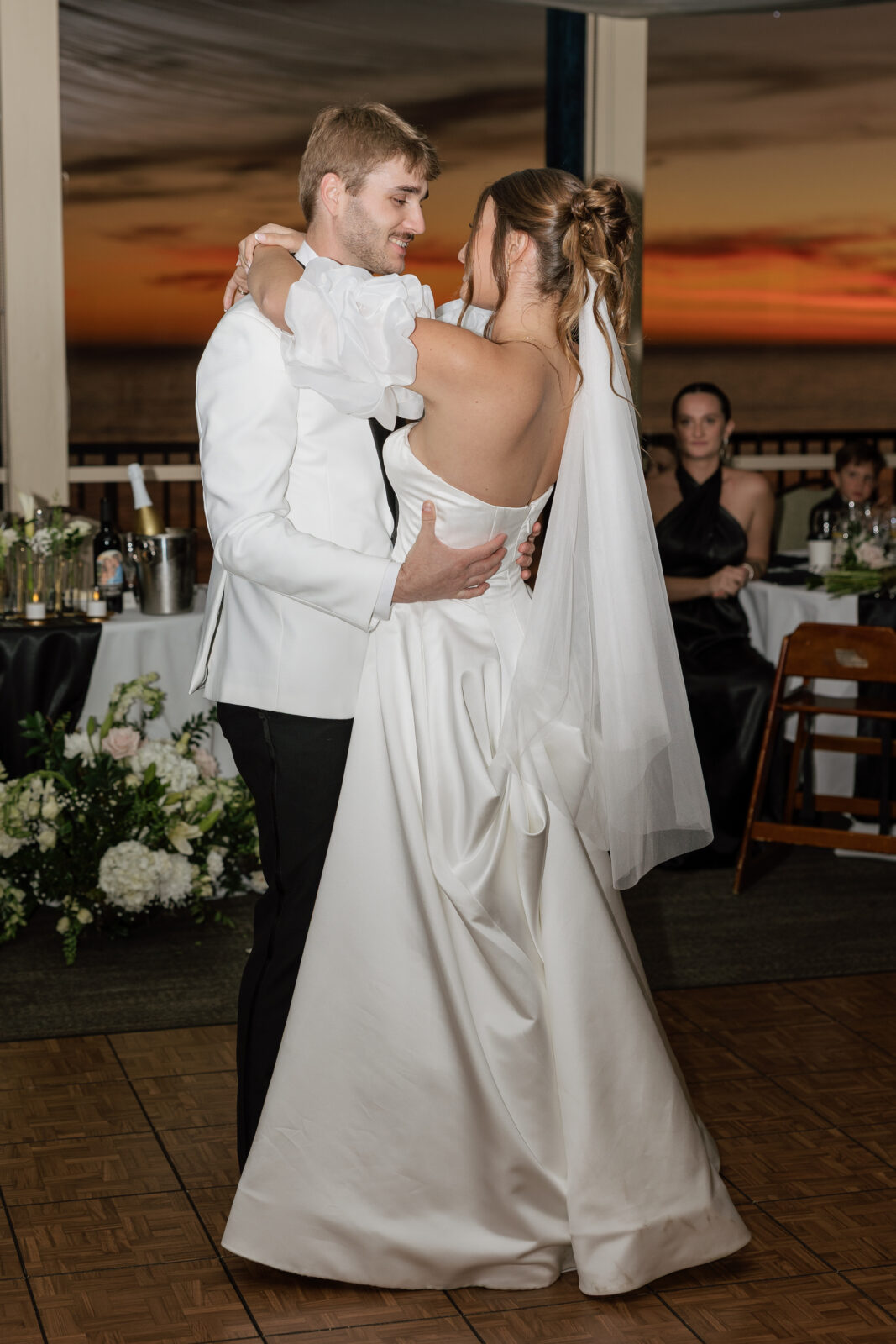 Bride and groom sharing their first dance as a married couple during their wedding reception in Pismo Beach, California, captured by Southern California wedding photographer