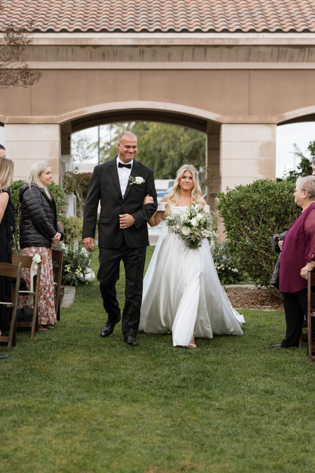 Sweet father daughter moment as bride walks down aisle at Riverside CA wedding 