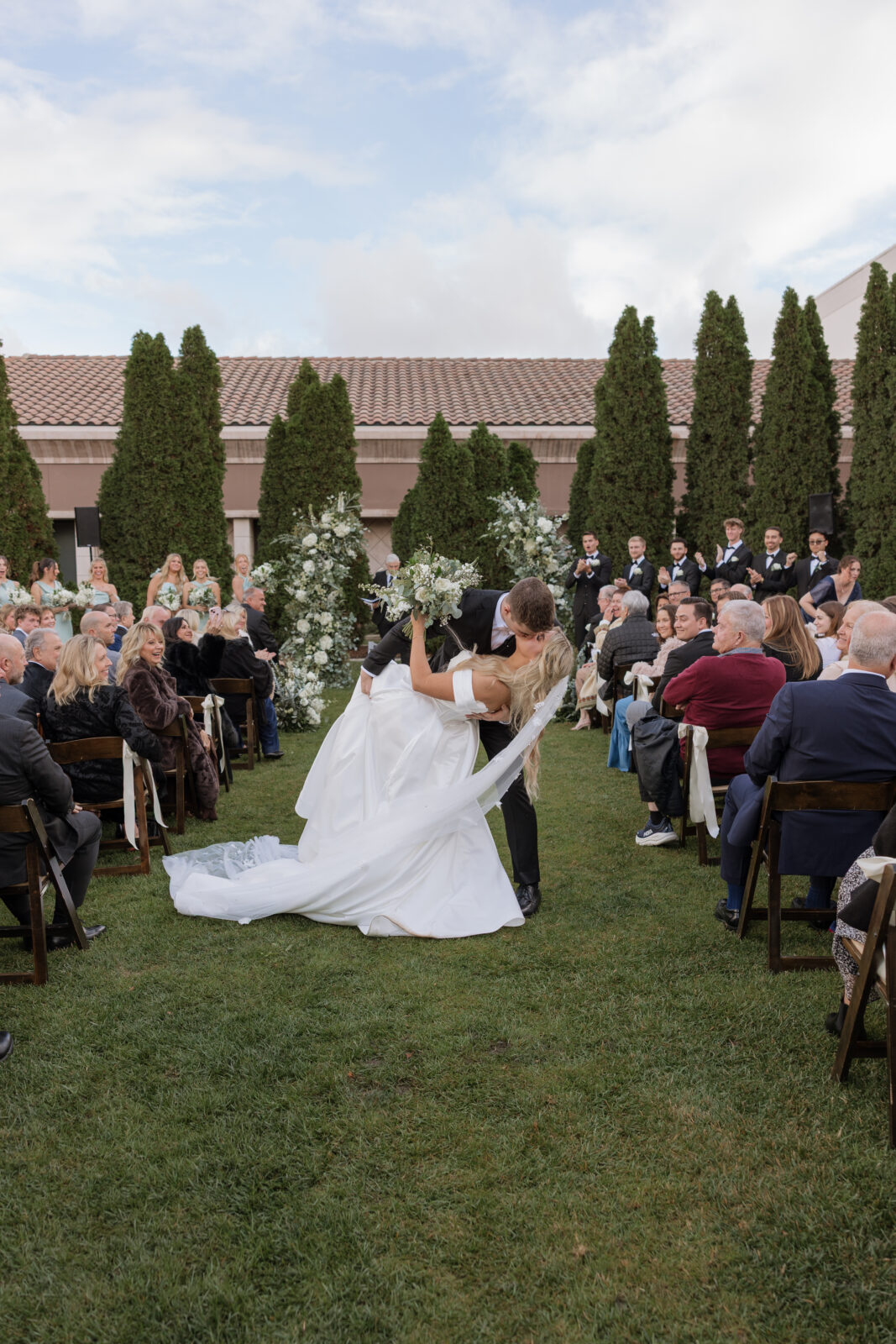 Bride and groom wedding ceremony dip kiss Riverside CA taken by KASSIDY KLICKS