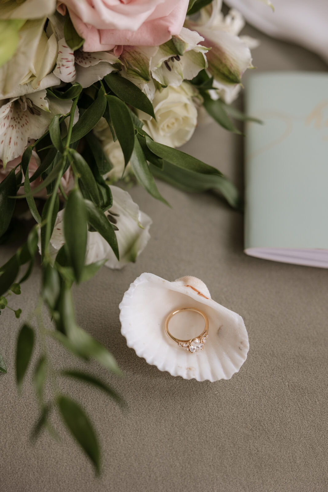 Flat lay detail of wedding rings styled elegantly on wedding day in Pismo Beach, California, captured by Southern California wedding photographer