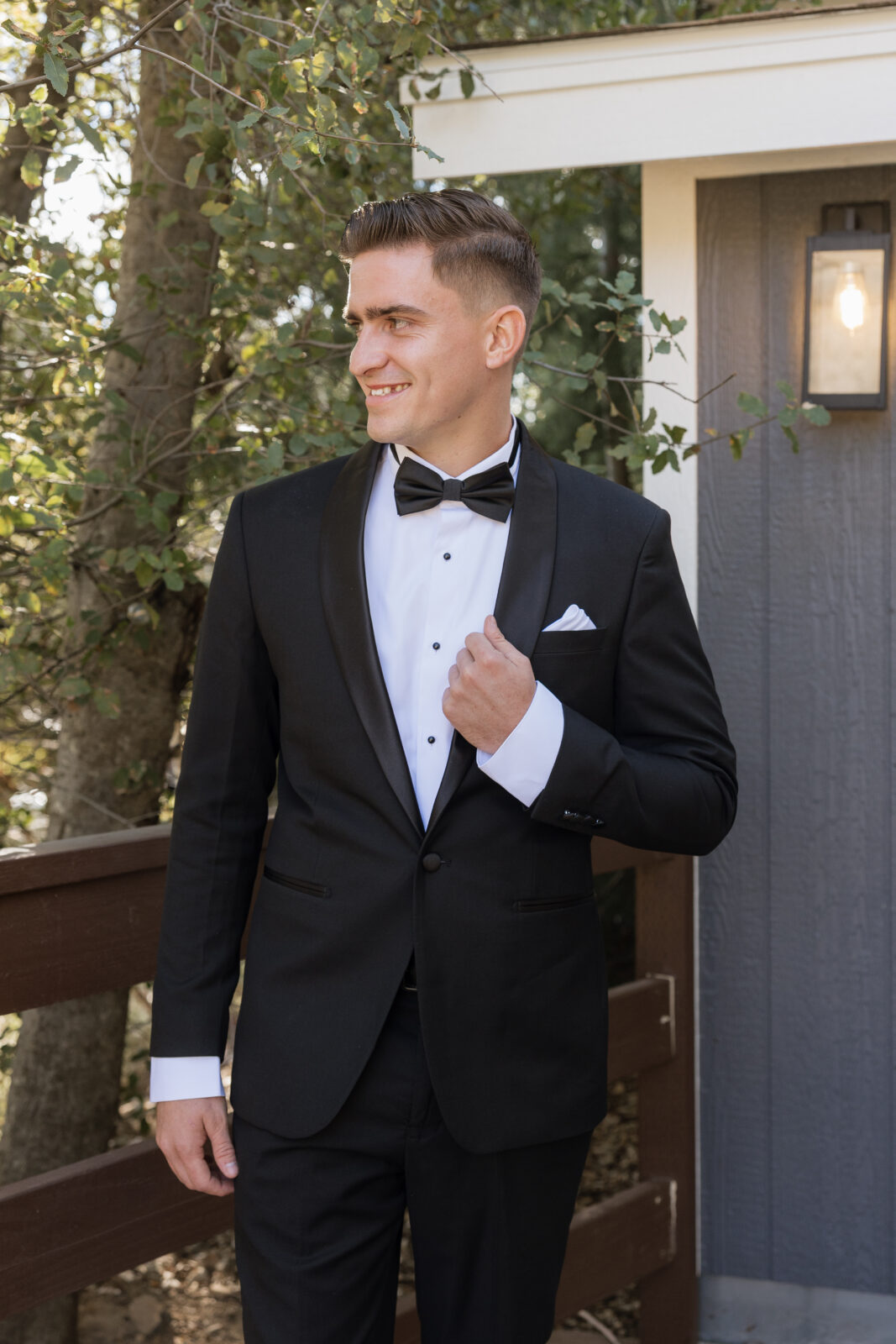 Groom Blake getting ready for his wedding at Serendipity Garden in Oak Glen, California, adjusting his suit before the ceremony