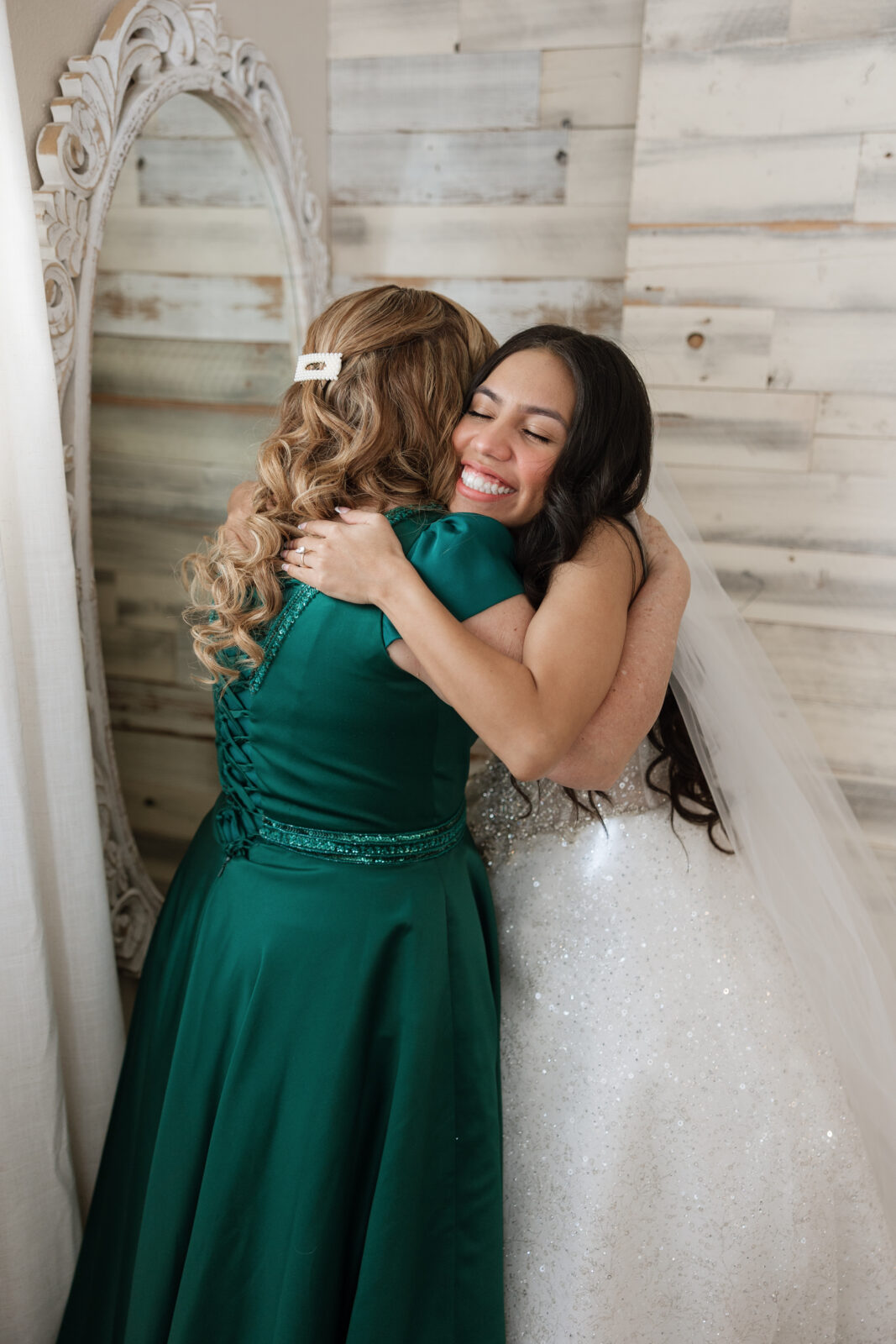 Bride Chelsea hugging her mom after getting into her wedding dress at Serendipity Garden in Oak Glen, California, emotional getting ready moment