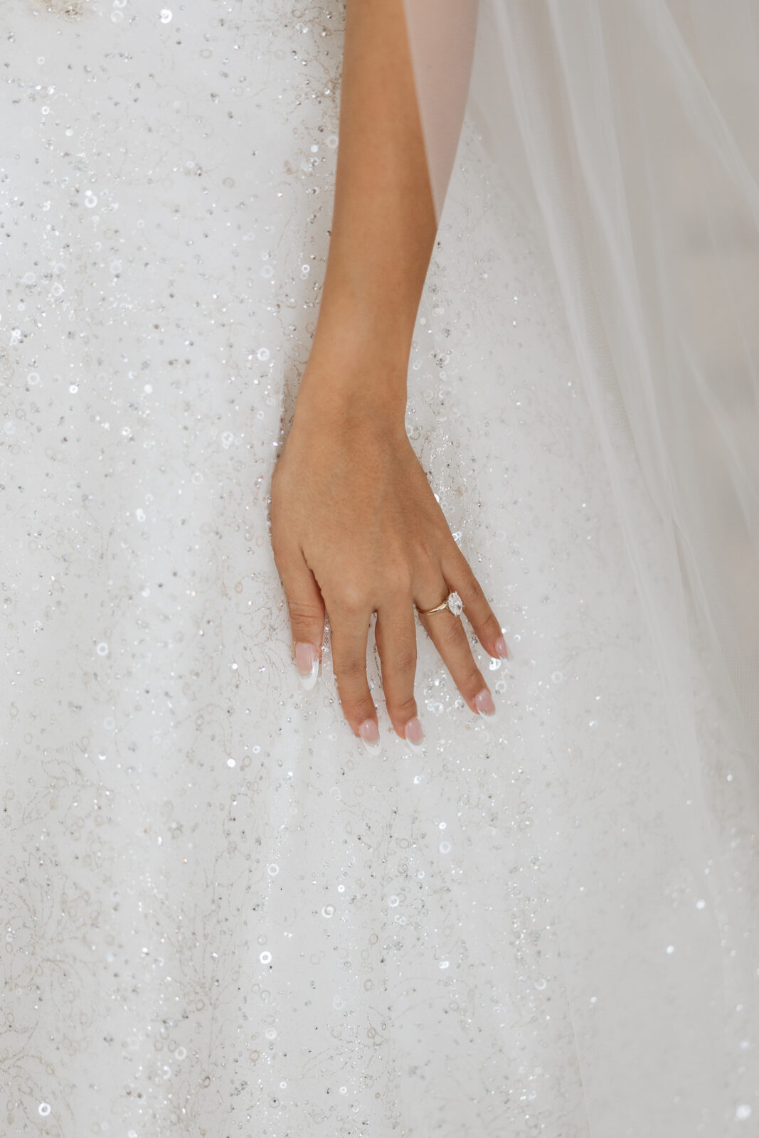 Close-up of Chelsea’s wedding ring on her bridal gown at Serendipity Garden wedding venue in Oak Glen, Southern California