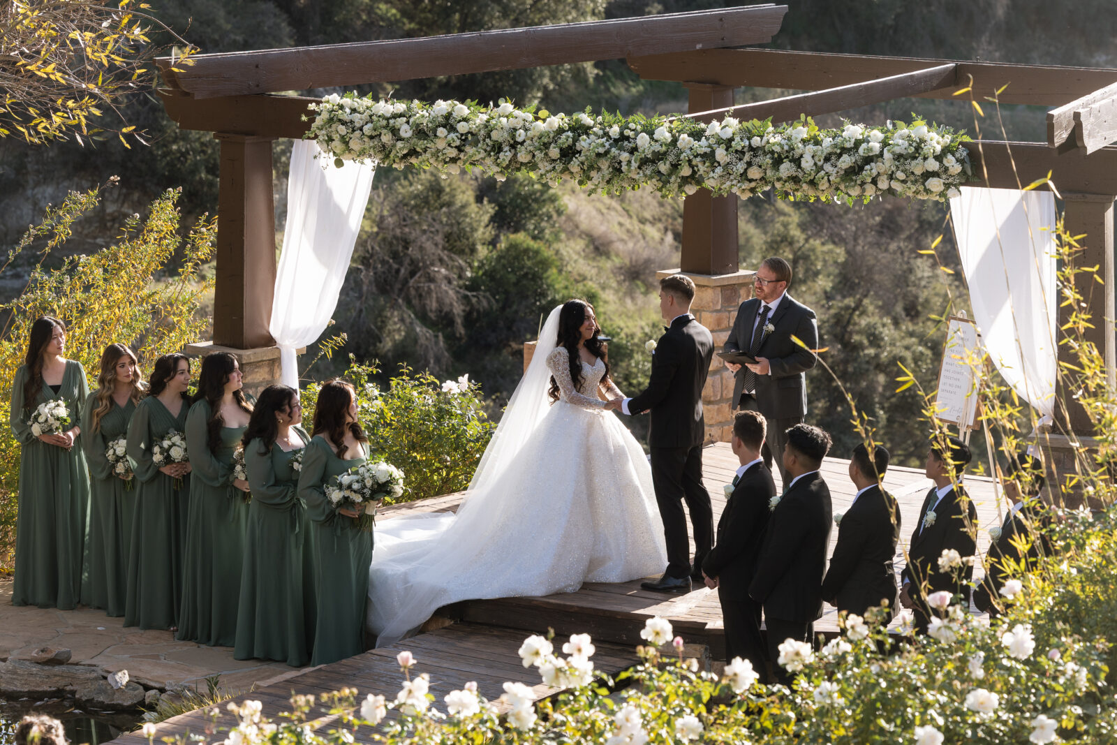 Bride and groom standing at the altar during their Serendipity Garden wedding ceremony in Oak Glen, Southern California
